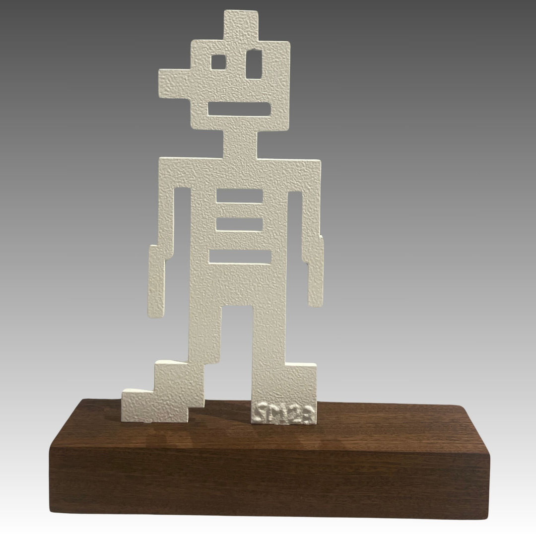 Minimal robotic figure made of squares and rectangle cut outs mounted on a black of wood, white steel sculpture