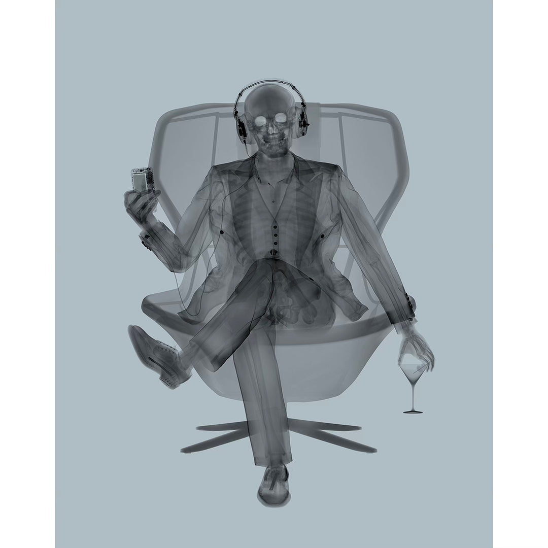 skeleton figure x ray man in suit holding wine and listening to headphone cassette on modern chair in black and grey surrealism pop 