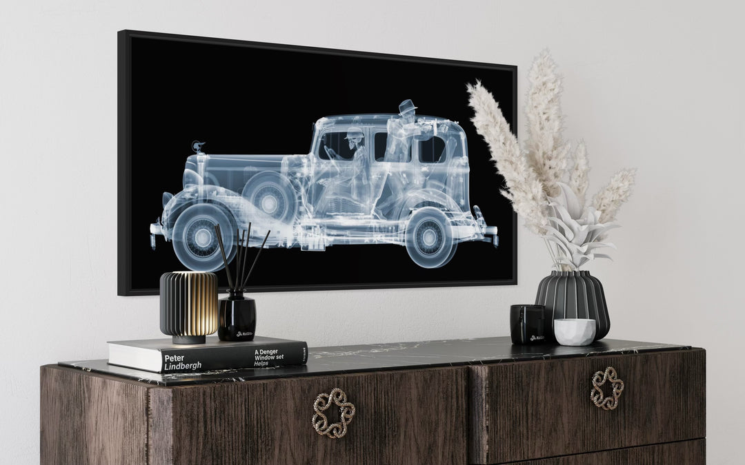 Framed Chromaluxe black and white x-ray photograph by Nick Veasey of a skeleton 1930s gangsters in a pontiac getaway car, pointing a vintage machine gun