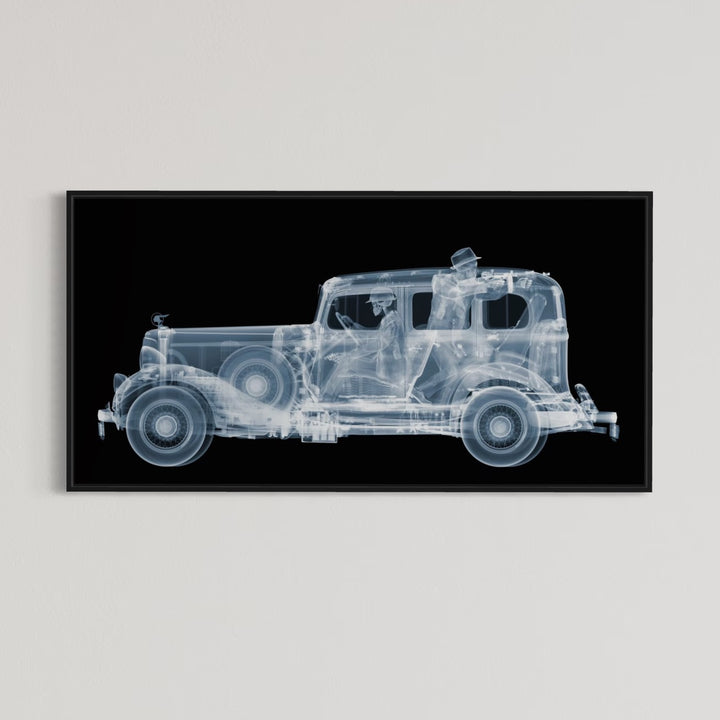 Framed Chromaluxe black and white x-ray photograph by Nick Veasey of a skeleton 1930s gangsters in a pontiac getaway car, pointing a vintage machine gun