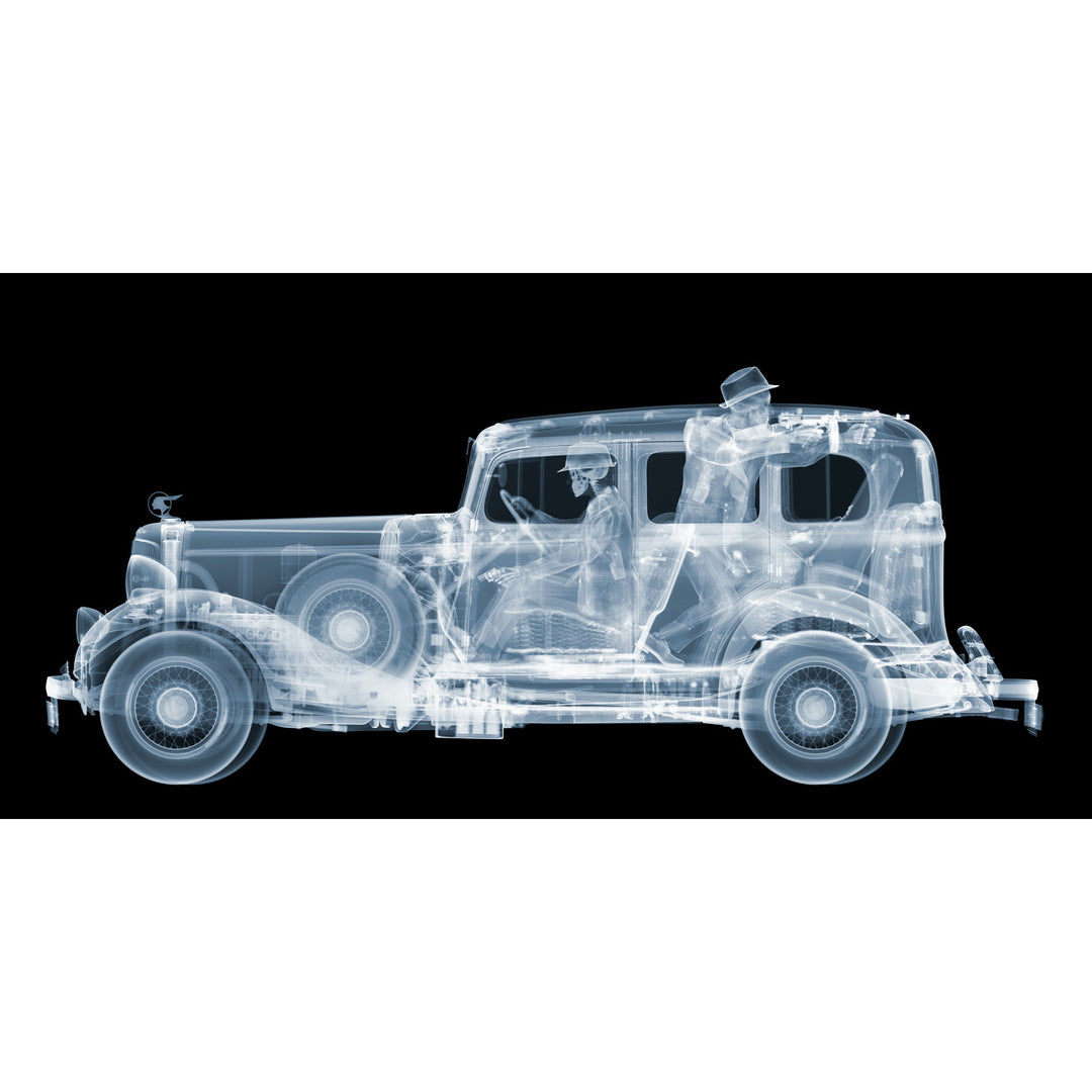 Framed Chromaluxe black and white x-ray photograph by Nick Veasey of a skeleton 1930s gangsters in a pontiac getaway car, pointing a vintage machine gun