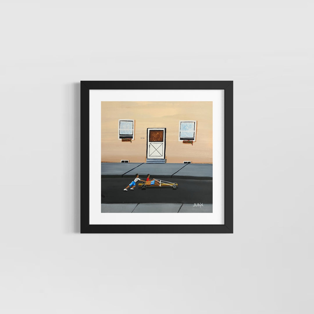 two boys playing race car in street outside of house with door and windows