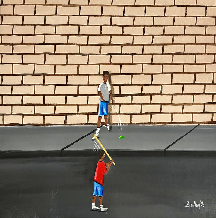 two boys playing outside game with stick and ball in street in front of brick wall