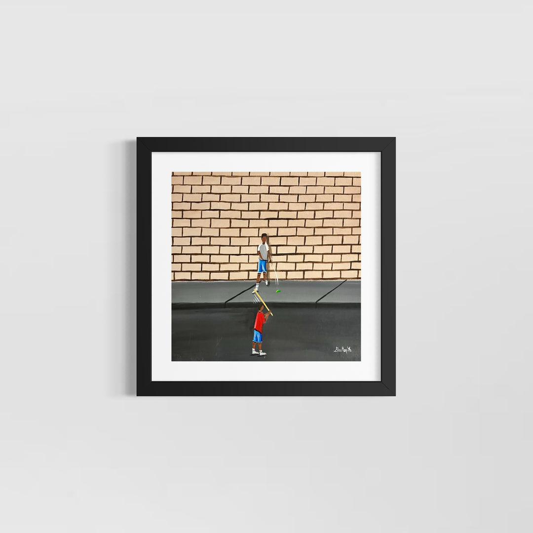 two boys playing outside game with stick and ball in street in front of brick wall