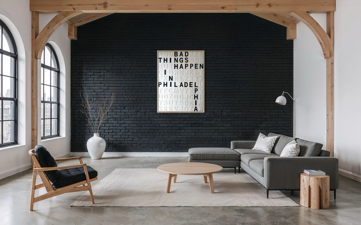 Steffanie Gerkin’s Bad Things White 3D is a contemporary mixed-media typography artwork made with raised wood and acrylic letters on canvas, featuring a white alphabet grid with bold black letters that spell “Bad Things Happen in Philadelphia.”
