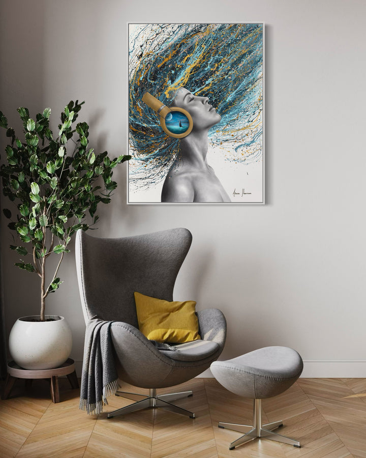 woman side profile face in black and white wearing gold headphones with sea scene flipping hair back in blue black and gold splatter paint on white background