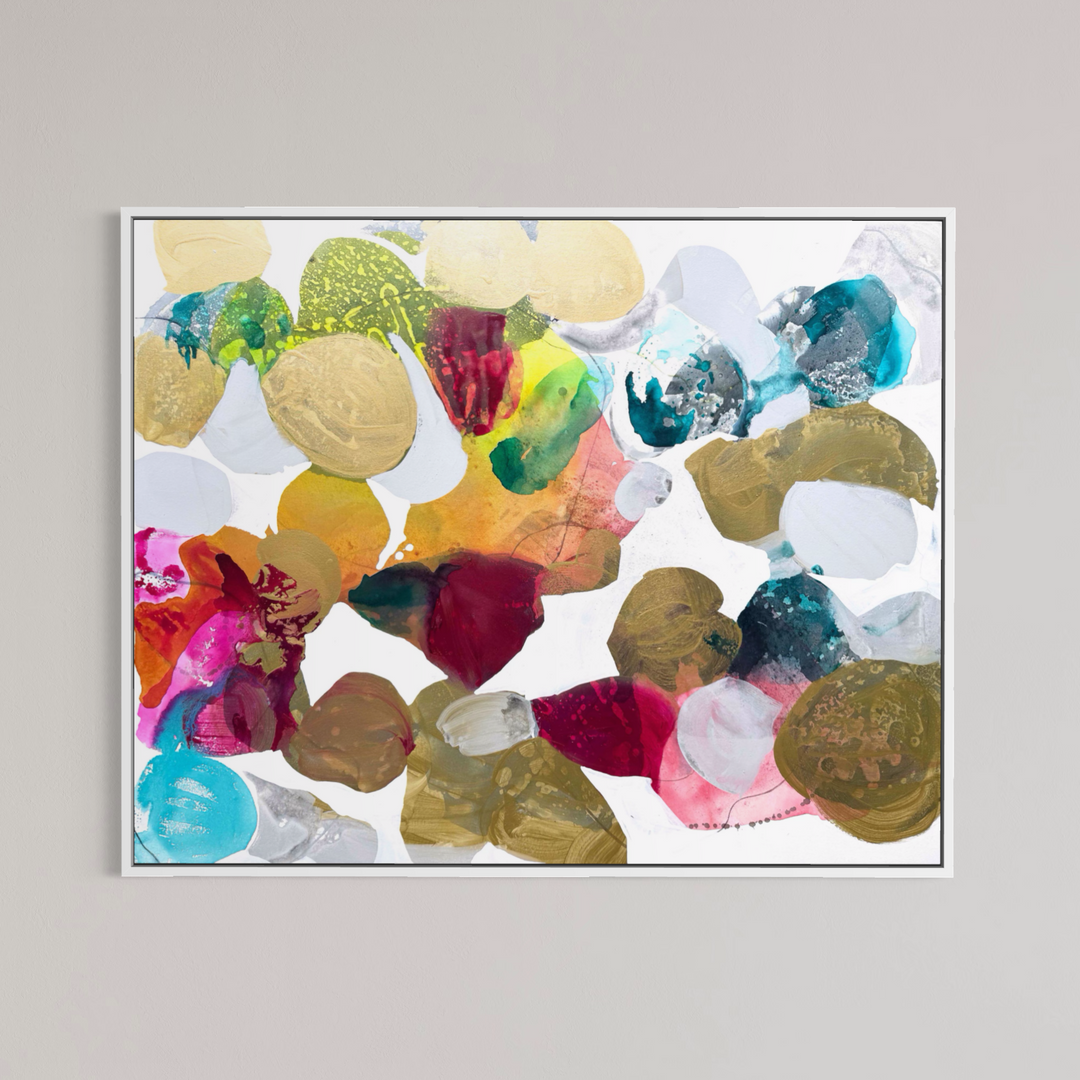 Liz Barber, Butterflies 3, acrylic paint, ink, and watercolor on canvas, 60 x 48 inches. Abstract composition of rounded shapes in metallic gold, olive, crimson, magenta, orange, yellow, turquoise, teal, and white on a white background, shown in a thin white frame on a light gray wall.