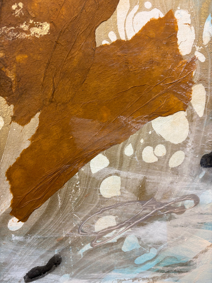 Close-up detail of Current Cameo showing the rust-brown organic leaf shape with gold highlights and white circular dot patterns over a soft blue-gray and silver background.