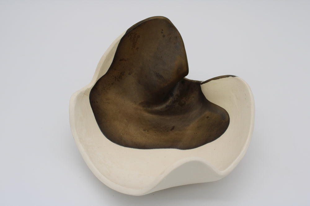fluid ceramic sculpture with brown bronze and cream 