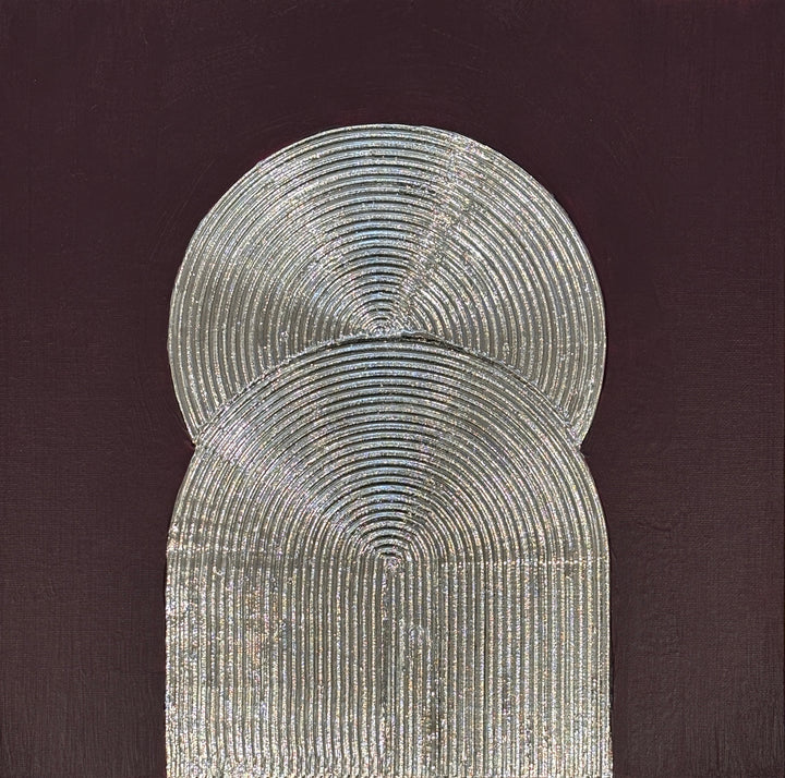 Lee in Cerulean, Eminence Duo I, joint compound, liquid leaf and acrylic, 14 x 14 inches. Two overlapping silver forms, a circle above an arch, both formed from concentric raised lines, on a dark plum background.