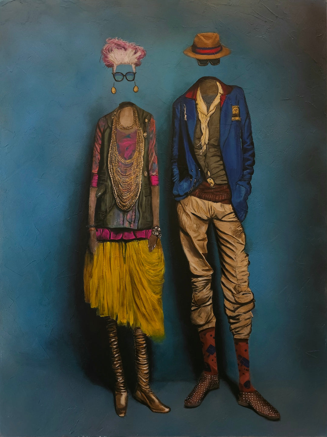 Neil Anthony Edwards, First Impression, oil painting. Two headless figures against a teal-blue background: a woman in a green vest, layered gold necklaces, pink top, yellow tulle skirt, and tall bronze boots, with floating pink feathered hair, round black glasses, and drop earrings, beside a man in a blue blazer, cream scarf, khaki trousers, patterned red socks, and studded shoes, with a floating tan fedora with a red band.