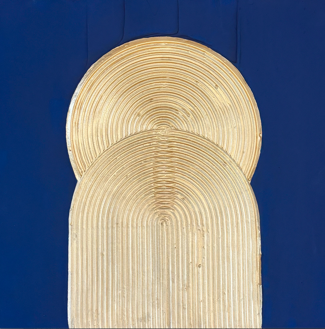 golden ridged with lines circle behind arching gold shape with ridges in vertical orientation on blue background
