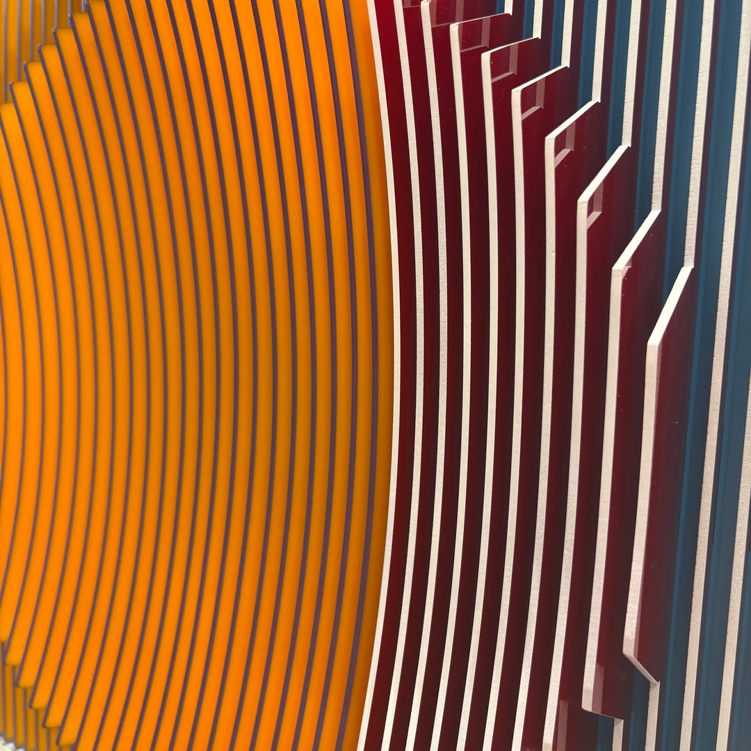 vertical stripes plexiglass abstract geometric with yellow and orange in back and pulsing round circular middle in blue when viewed at angle mostly red