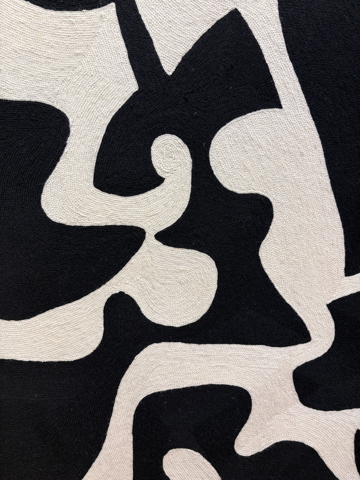 chain stitched textile embroidery abstract black and white negative space pattern shapes in wood frame