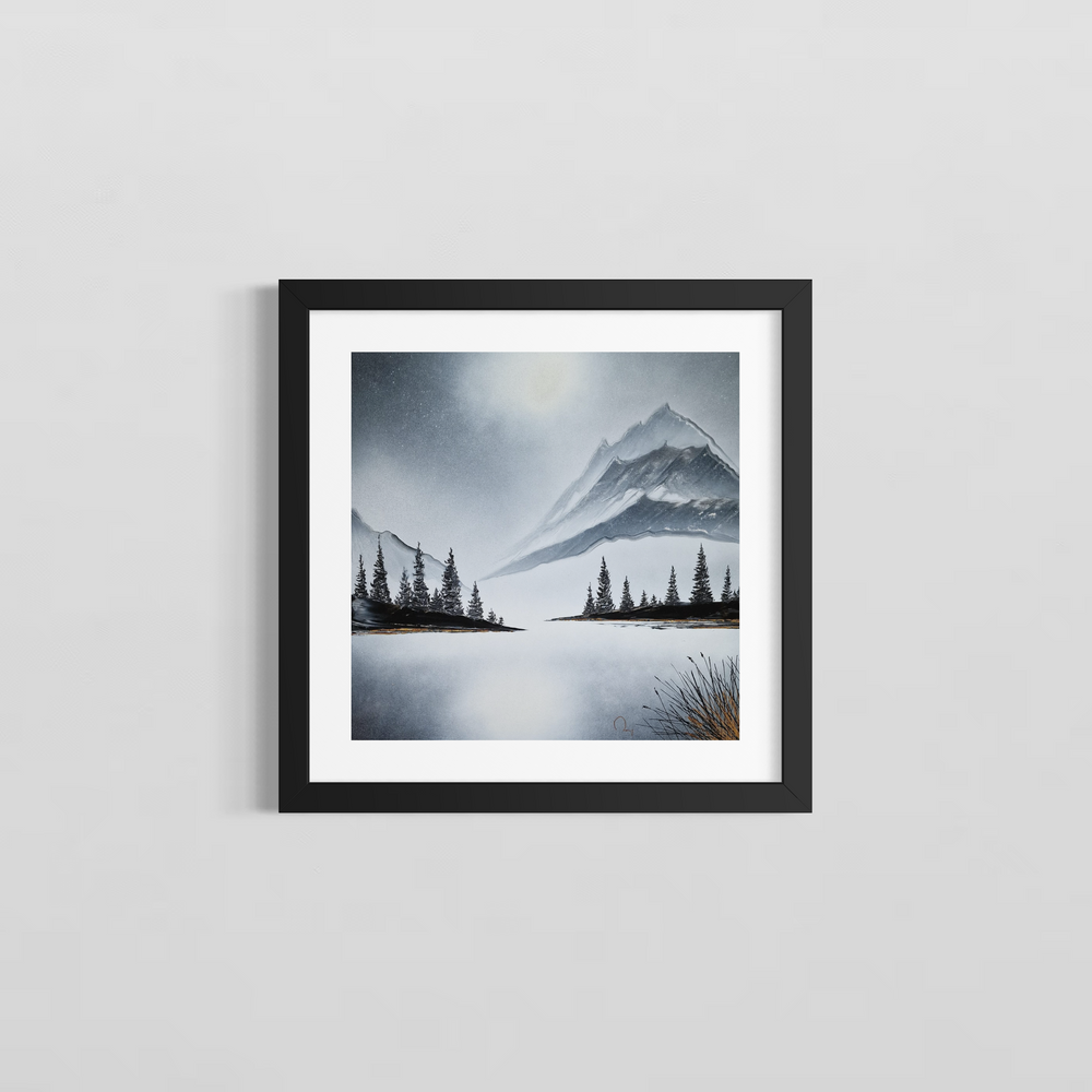 An abstract nature scene of a lake, trees, and mountains by Julien Rey. It is painted with black and white Chinese lacquer and gold leaf. Framed with a white mat an a black frame on a gray wall.