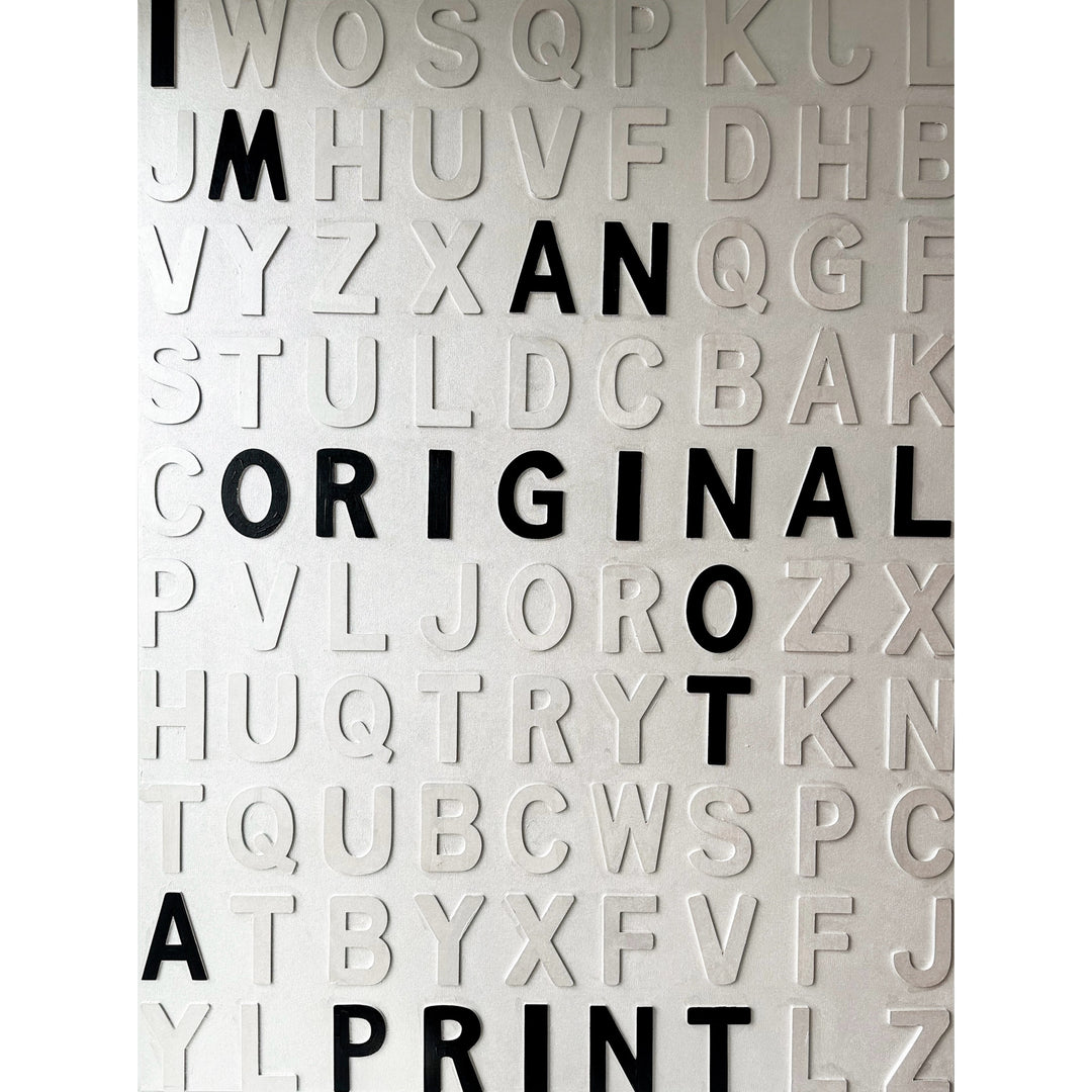 Contemporary 3D text artwork by Chicago artist Steffanie Gerkin titled I’m an Original 3D, featuring raised black and white wood letters arranged in a structured alphabet grid on a white canvas. The monochrome typographic composition spells the phrase “I’m an Original, Not a Print,” creating a bold conceptual wall art piece with graphic text-based design, pop art influence, and contemporary mixed-media style.