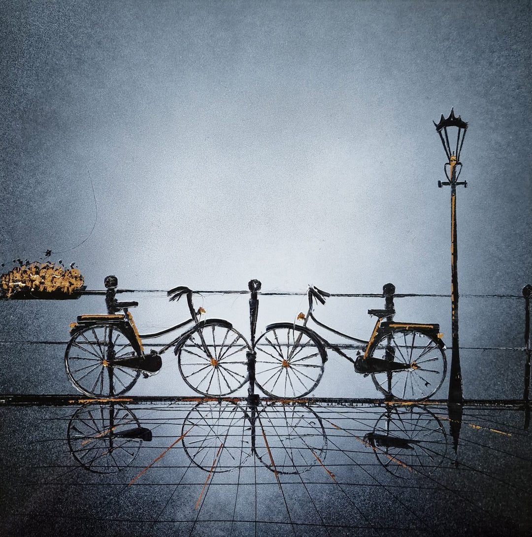 Two bikes facing each other that are parked on a reflective sidewalk with light posts and flower baskets around. Painted with black and white Chinese lacquer and gold leaf by Julien Rey. The gold highlights the light in the piece.