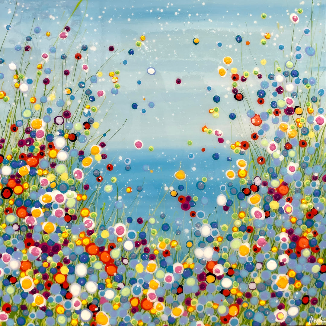 resin polkadots all over canvas in rainbow colors with sky blue background and white dots