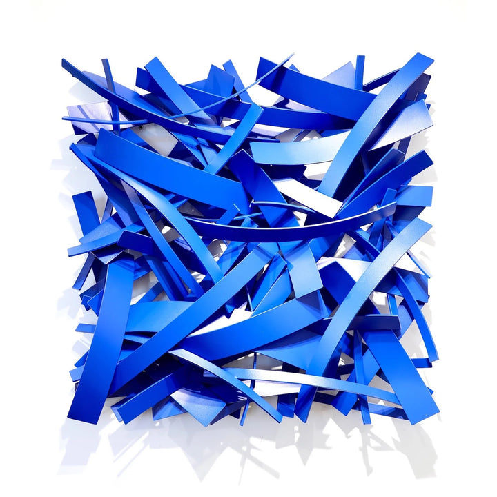 Matt Devine, Mixed Bands, powder-coated aluminum, made to order from 11 to 84 inches. Square wall sculpture of cobalt blue aluminum bands in mixed widths, layered in a crisscross pattern on a white wall.