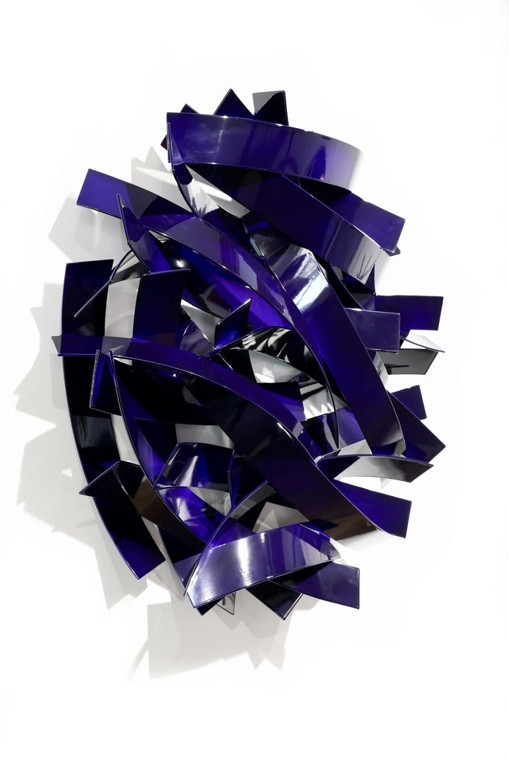 Matt Devine, Wide Bands, powder-coated aluminum, made to order from 11 to 84 inches. Oval wall sculpture of wide, curved glossy violet-blue aluminum bands layered in overlapping arcs on a white wall.