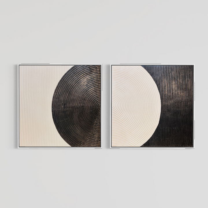 Lee in Cerulean, Monochrome Duo, joint compound and acrylic paint on canvas, 40 x 40 inches each (40 x 80 inches together). Two square black and cream textured panels, each in a thin white float frame, shown side by side on a light grey wall.