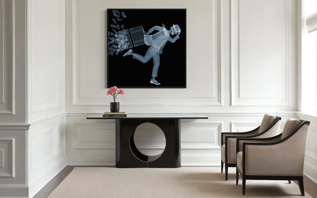 Framed Chromaluxe black and white x-ray photograph by Nick Veasey of a skeleton man in a fedora and suit running against the wind as his briefcase full of cash opens and the money blows away