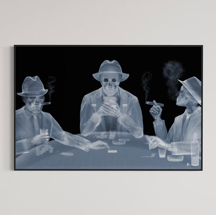 Framed Chromaluxe black and white x-ray photograph by Nick Veasey of three skeletal figures in fedoras and suits playing poker at a table and smoking cigars and holding drinks.