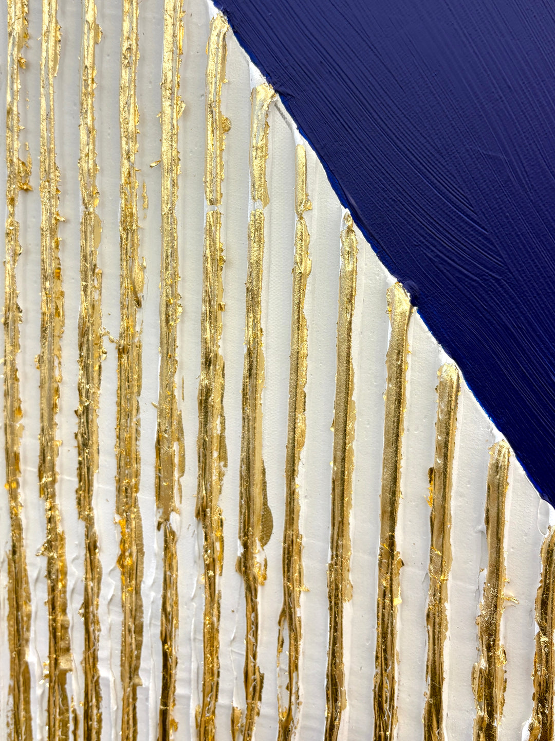 minimal geometric abstract sculptural work with joint compound texture dimension white rigid triangle with gold leaf detail on blue background