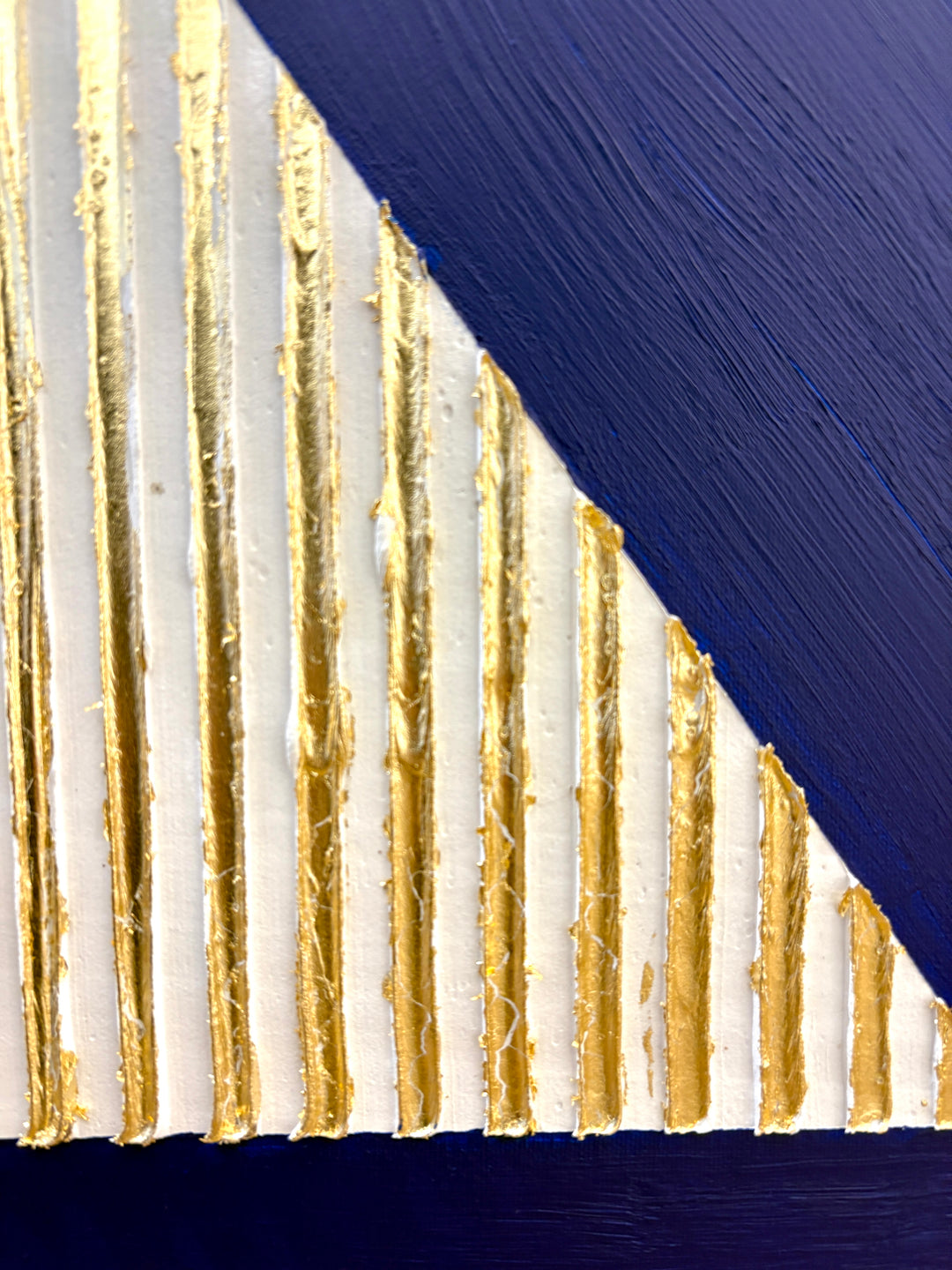 minimal geometric abstract sculptural work with joint compound texture dimension white rigid triangle with gold leaf detail on blue background