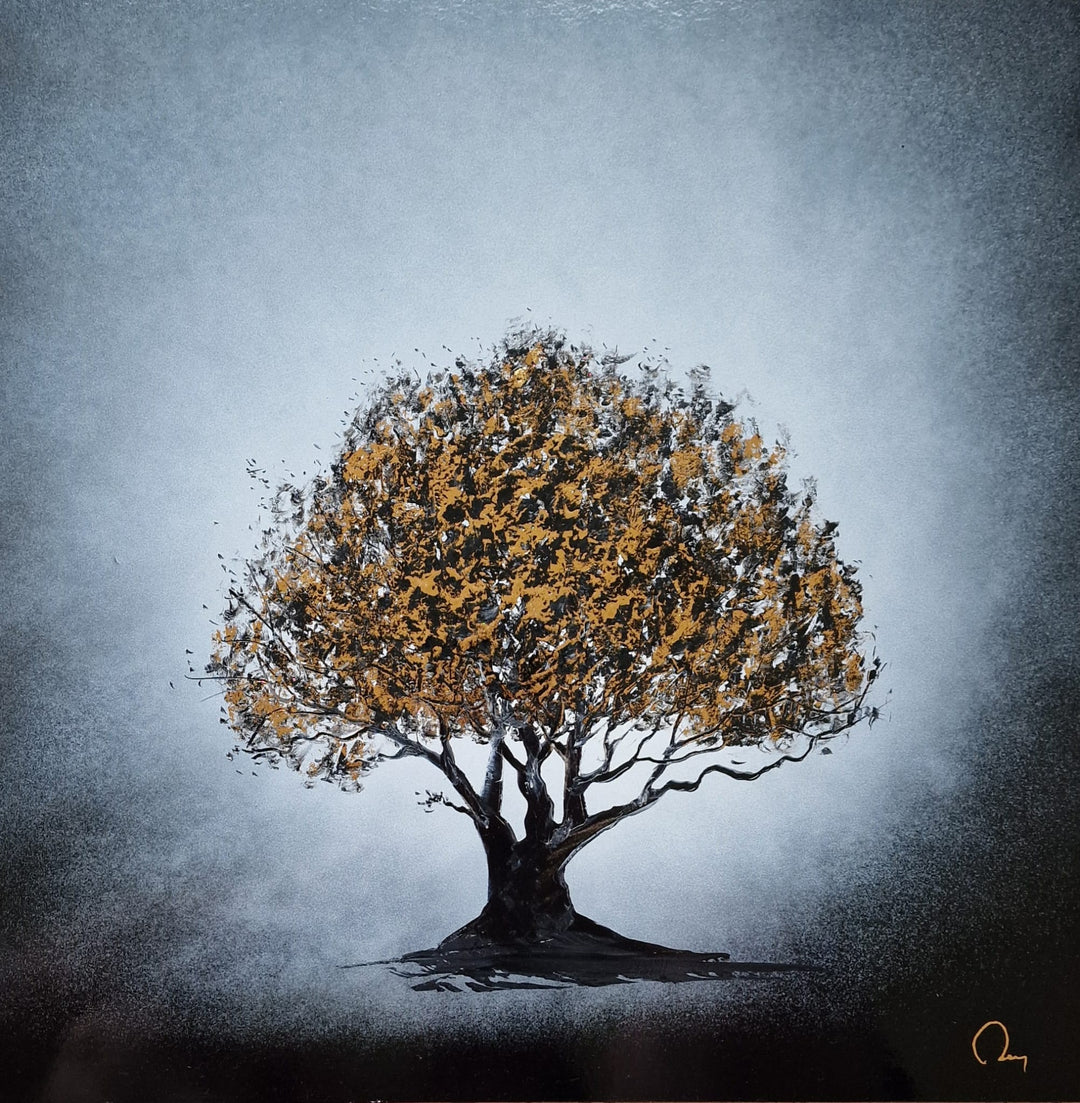 Tree of Life" by French artist Julien Rey — a mixed-media painting of a solitary ancient tree crafted with Chinese lacquer and gold leaf on board. A magnificent, full-canopied tree with richly textured gold leaf foliage and gnarled black lacquer branches rises from dark earth against a luminous silver-gray atmospheric background. A timeless symbol of strength, growth, and resilience. Original contemporary Tree of Life painting available at Morton Contemporary gallery.