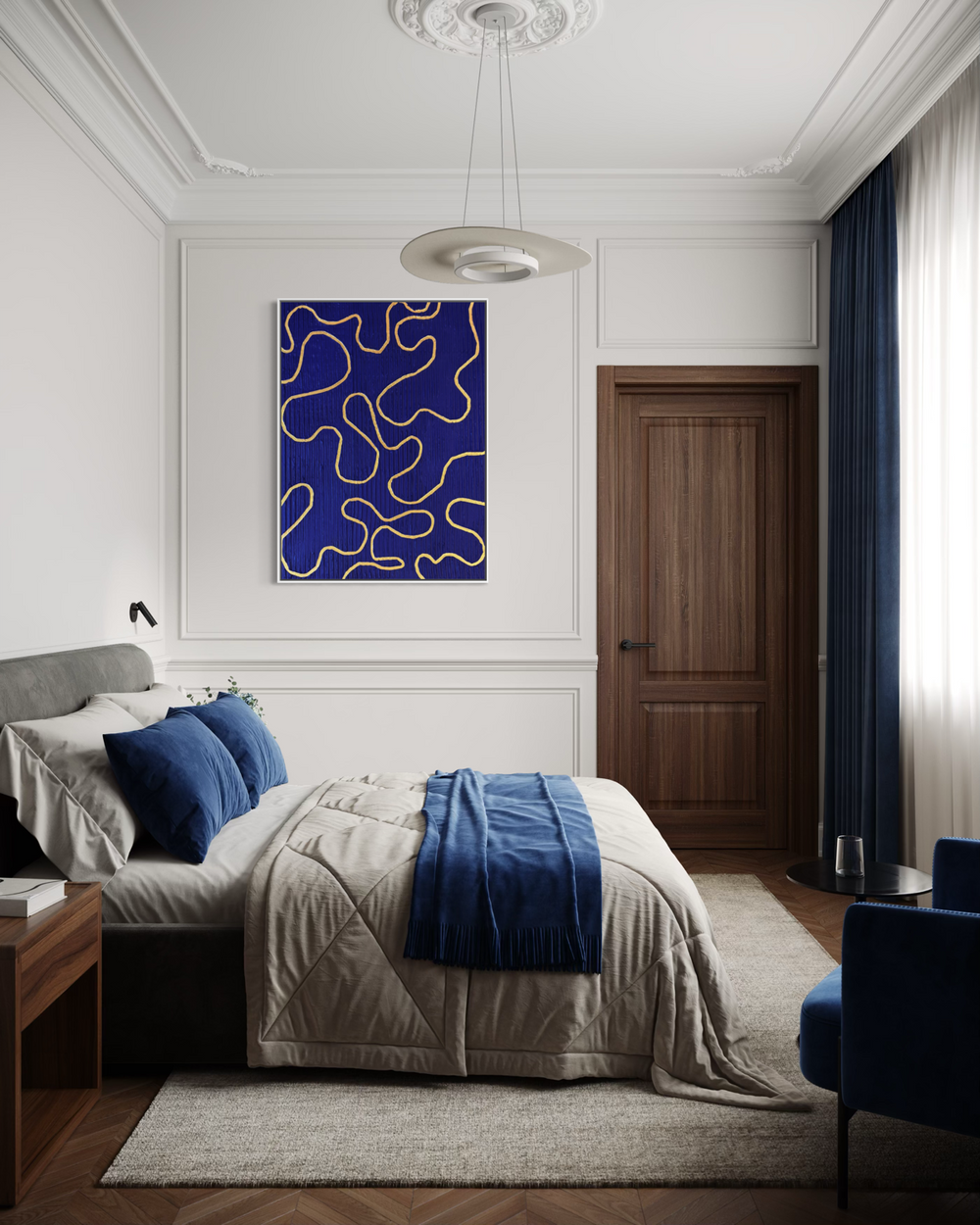 Lee in Cerulean, Vaste Wilderness, joint compound and acrylic paint on canvas, 48 x 36 inches. Deep blue painting with looping gold lines hung above a bed in a white-paneled bedroom with blue pillows and throw, a wood nightstand, and a wood door.