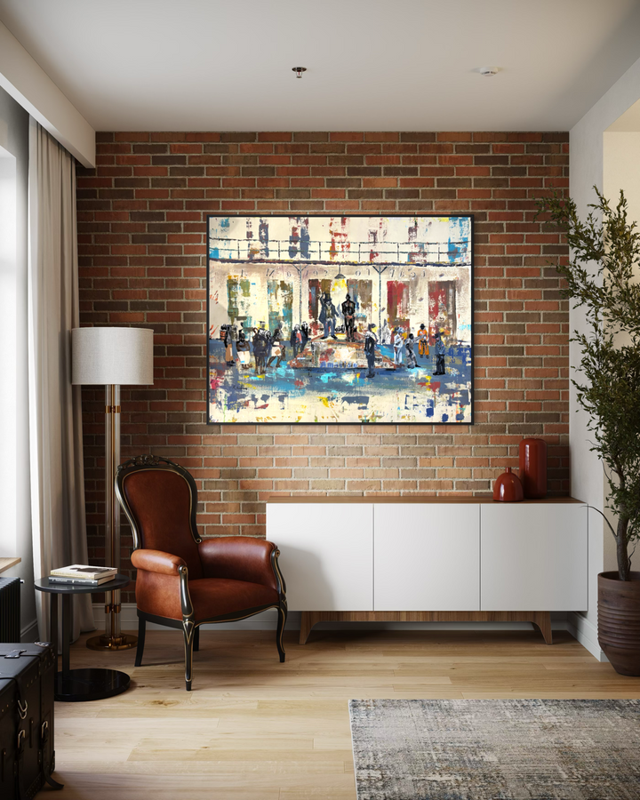 Keith Andrews, Block to Block, acrylic and collage on parachute cloth, 48 x 60 inches, shown framed on an exposed brick wall above a white sideboard, beside a brown leather armchair, a floor lamp and a potted olive tree.