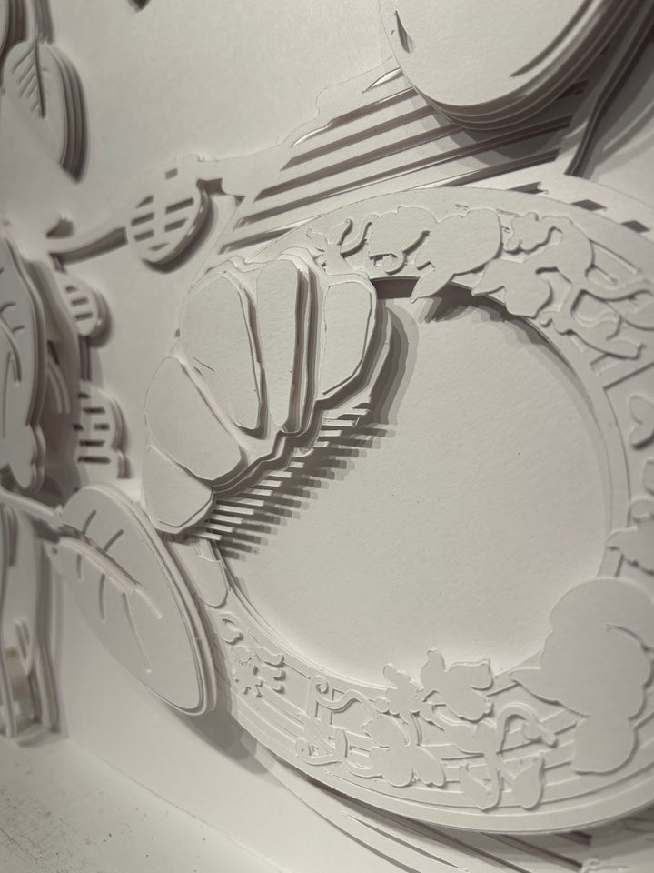 14"x14" layered white paper forming a table with breakfast and vegetation.  