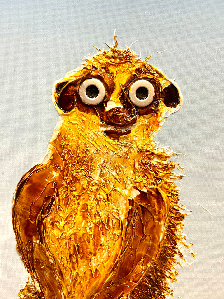 30” x 30” painting by French artist Moogly of three goldish-brown merecats. The two merecats on the sides look left and right while the smallest one in the middle looks straightforward with a light blue background. The merecats are made out of resin, giving them a textured and shiny finish. Their eyes are made out of washers that the artist has adhered to the canvas.