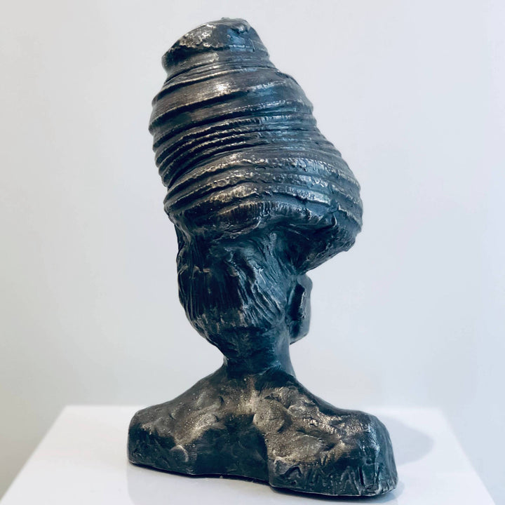 Shit On The Top, sculpture by Michal Cimala. Galvanized silver with polyurethane. 8 by 4.75 by 4.75 inches.